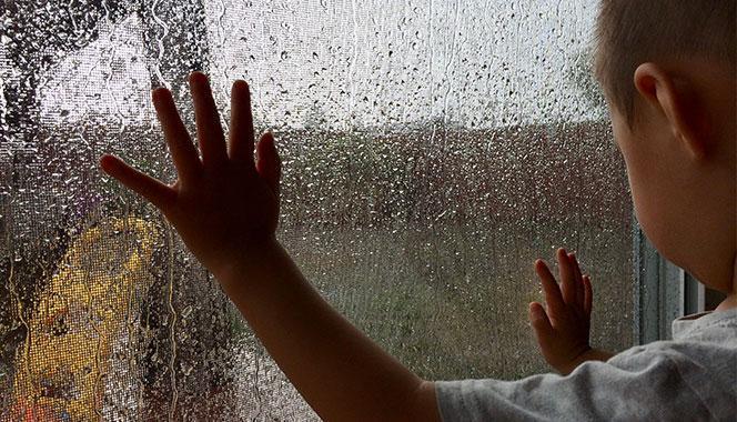 Kid Inside Rainy Window