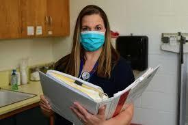 School Nurse Holding a Binder