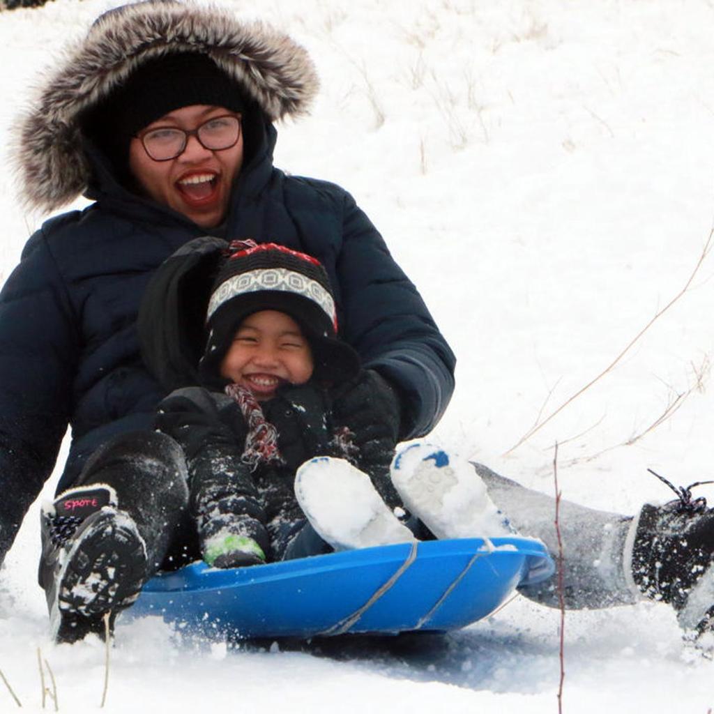 Parent and child sledding