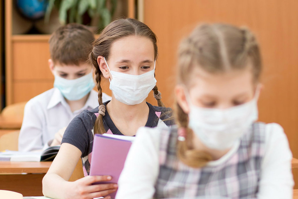 Students at desks in masks
