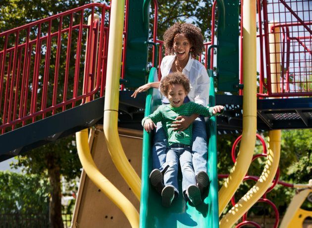 Mom & Child Sliding Down Slide