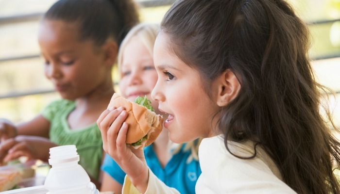 Kids eating sandwich outside