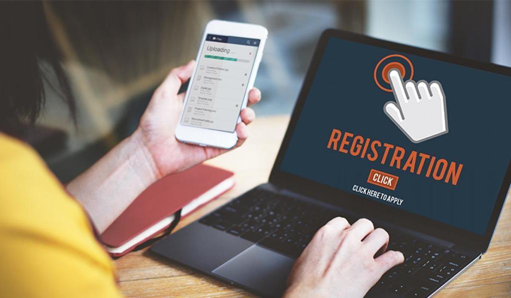 Person using computer and phone to register student
