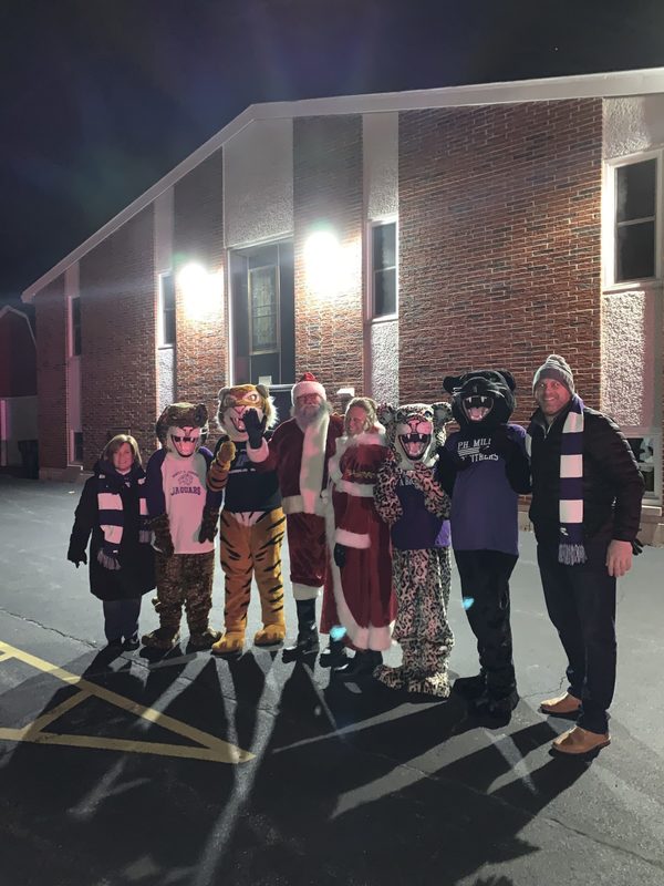 All school district mascots line up to take a picture together. 